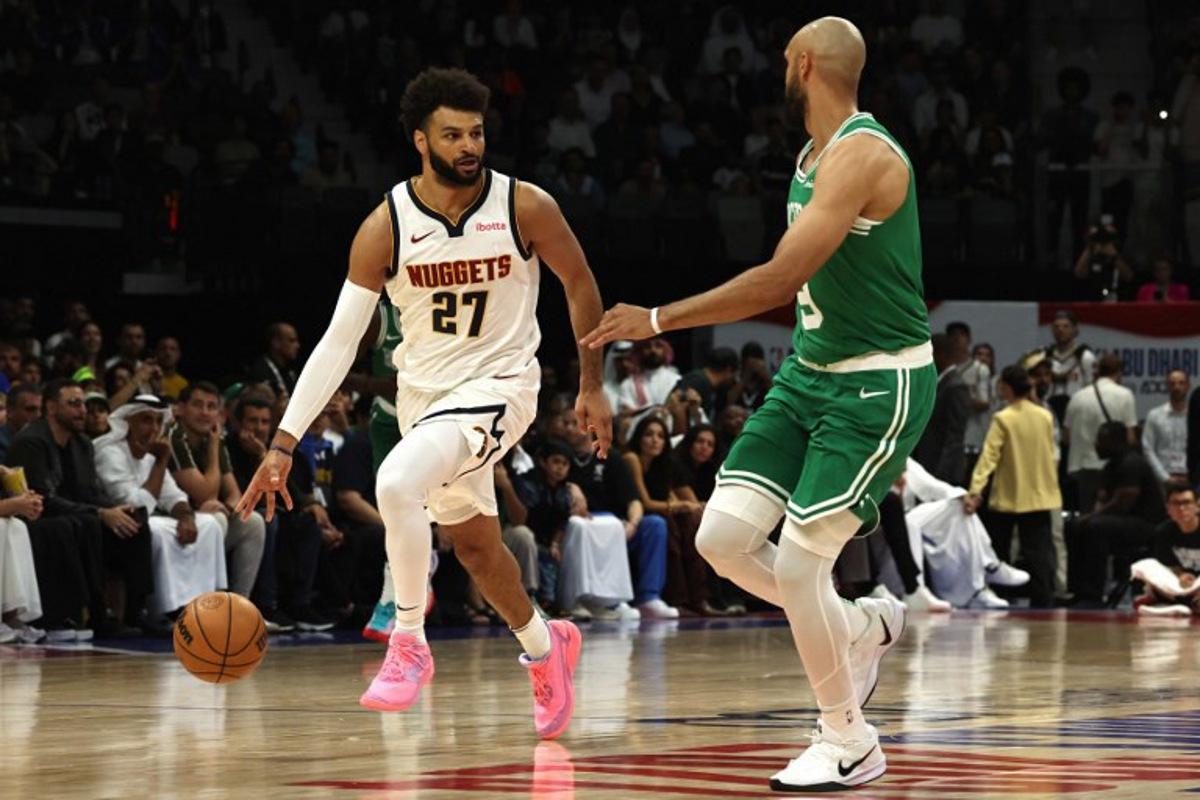 Denver Nuggets' guard #27 Jamal Murray fights for the ball with Boston Celtics' guard #09 Derrick White during the NBA Preseason game between the Denver Nuggets and the Boston Celtics at the Etihad Arena in Abu Dhabi on October 4, 2024. Fadel Senna / AFP