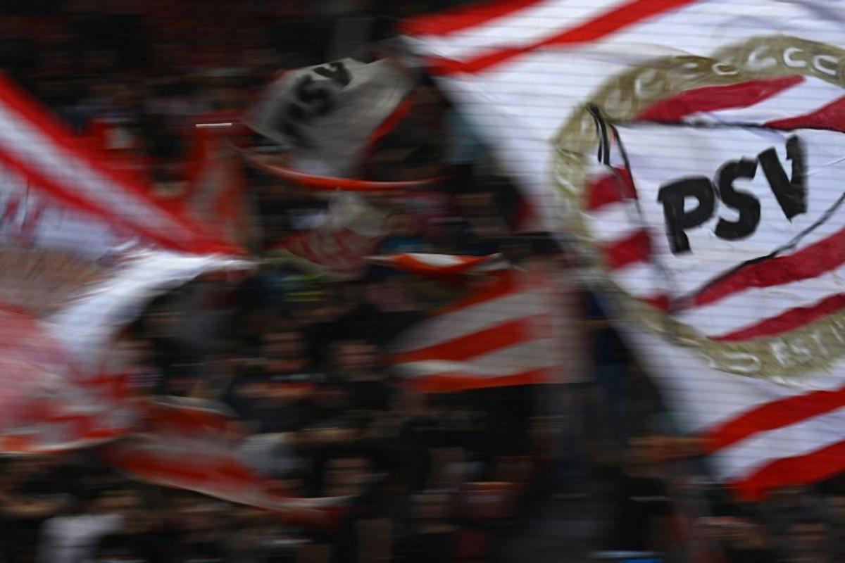 PSV Eindhoven's supporters wave flags during the UEFA Europa League football 1st round day 3 group A match between FC Zurich and PSV Eindhoven at Letzigrund stadium in Zurich on October 6, 2022. SEBASTIEN BOZON / AFP