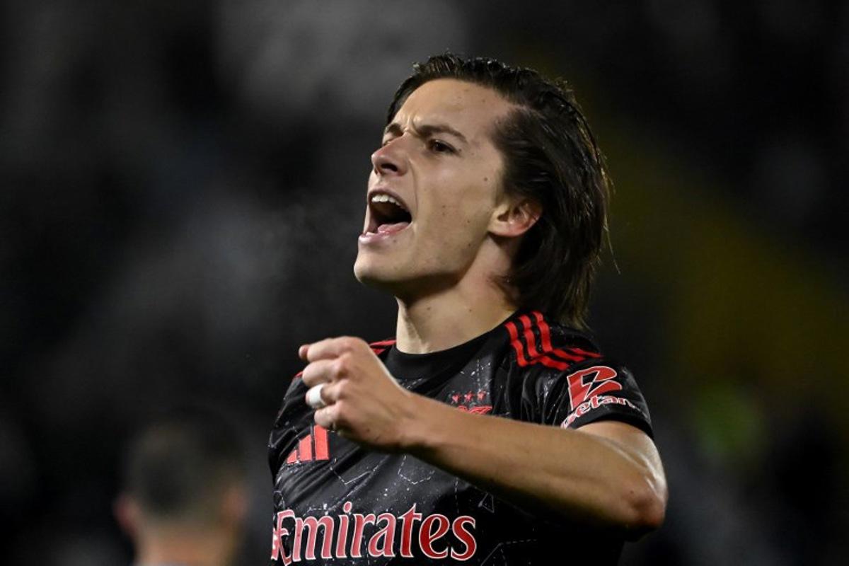 Benfica's Spanish defender #03 Alvaro Fernandez Carreras celebrates after scoring during the Portuguese League football match between Vitoria Guimaraes SC and SL Benfica at the Dom Afonso Henriques stadium in Guimaraes, Portugal, on April 19, 2025. MIGUEL RIOPA / AFP
