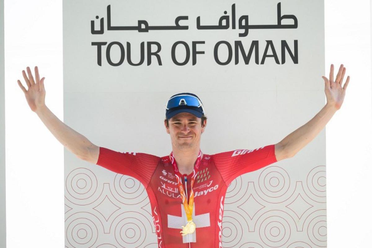 Team Jayco AlUla Swiss rider Mauro Schmid celebrates on the podium after winning the 3rd stage of the Tour of Oman cycling race from Samail "Al Fayhaa Resthouse" to Misfat Al Abriyeen, on February 9, 2026. Loic VENANCE / AFP