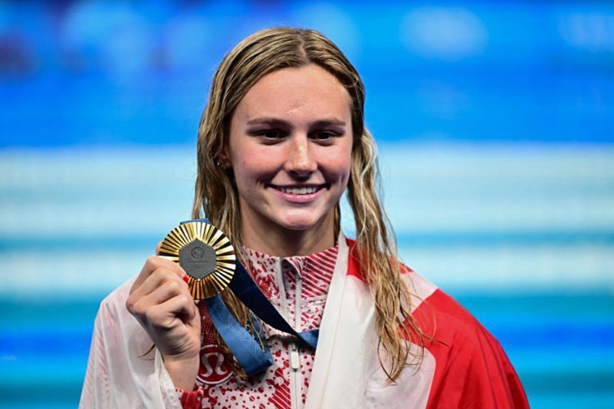 Gold medallist Canada's Summer Mcintosh celebrates during the podium ceremony of the women's 200m individual medley swimming event during the Paris 2024 Olympic Games at the Paris La Defense Arena in Nanterre, west of Paris, on August 3, 2024. Manan VATSYAYANA / AFP