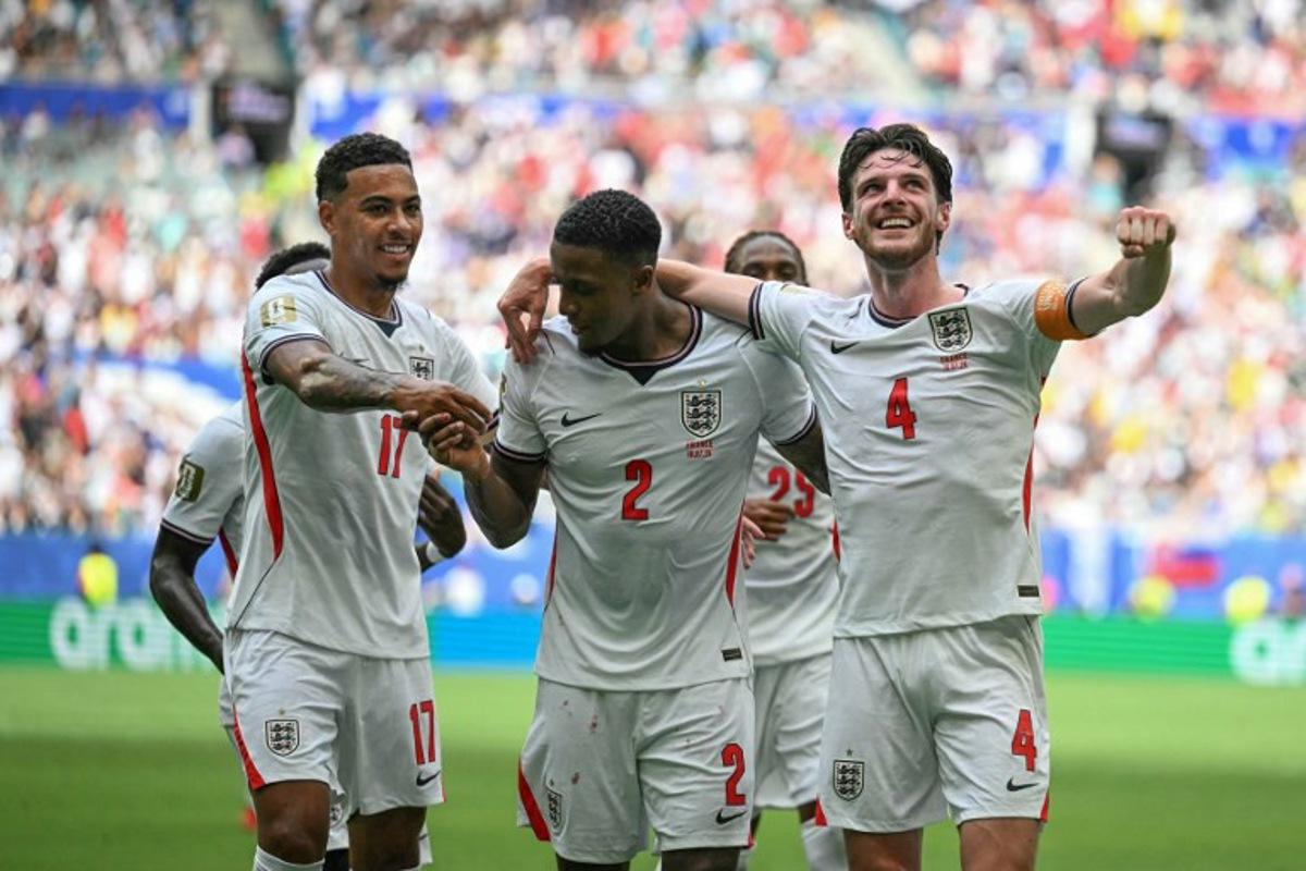 England's defender #02 Ezri Konsa celebrates scoring his team's second goal with England's midfielder #17 Morgan Rogers and England's midfielder #04 Declan Rice during the 2026 World Cup football tournament third-place match between France and England at the Miami Stadium in Miami on July 18, 2026. CHANDAN KHANNA / AFP