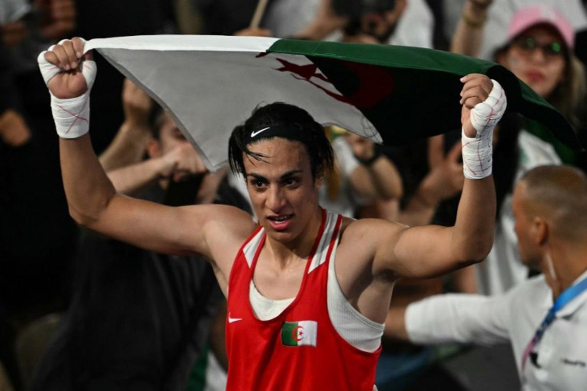 Algeria's Imane Khelif reacts after beating China's Yang Liu (Blue) in the women's 66kg final boxing match during the Paris 2024 Olympic Games at the Roland-Garros Stadium, in Paris on August 9, 2024. Mauro PIMENTEL / AFP