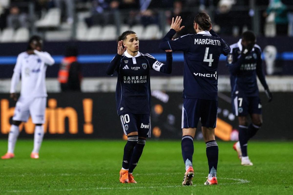Paris FC's French midfielder #10 Ilan Kebbal (L) celebrates after shooting a penalty and kick and scoring his team first goal with Paris FC's French midfielder #04 Vincent Marchetti (R) during the French L1 football match between Paris FC and AJ Auxerre at the Stade Jean-Bouin stadium, in Paris, on November 29, 2025. FRANCK FIFE / AFP