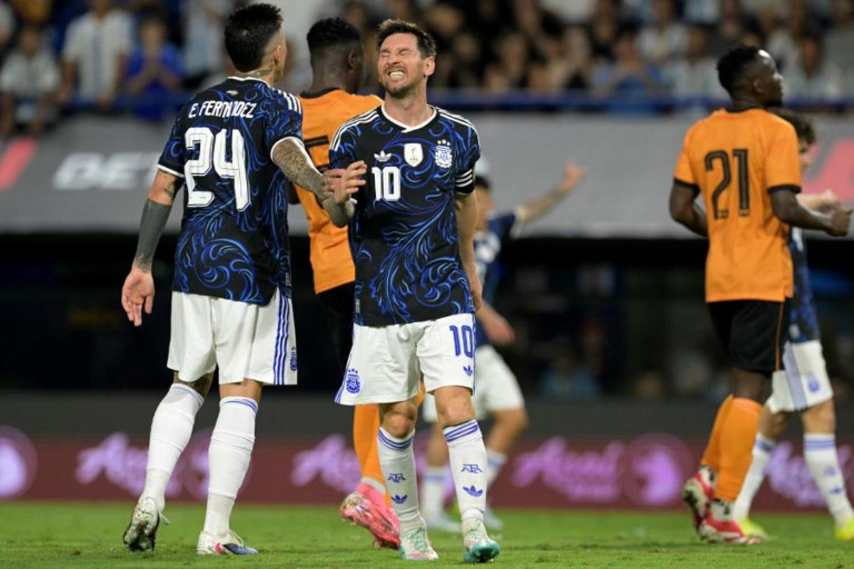 Argentina's forward #10 Lionel Messi gestures next to teammate midfielder #24 Enzo Fernandez during a friendly football match between Argentina and Zambia at La Bombonera stadium in Buenos Aires on March 31, 2026. JUAN MABROMATA / AFP