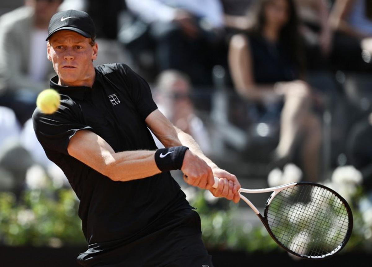 Italy's Jannik Sinner hits a return to Italy's Andrea Pellegrino during the ATP Rome Open tennis tournament at Foro Italico in Rome on May 12, 2026. Tiziana FABI / AFP
