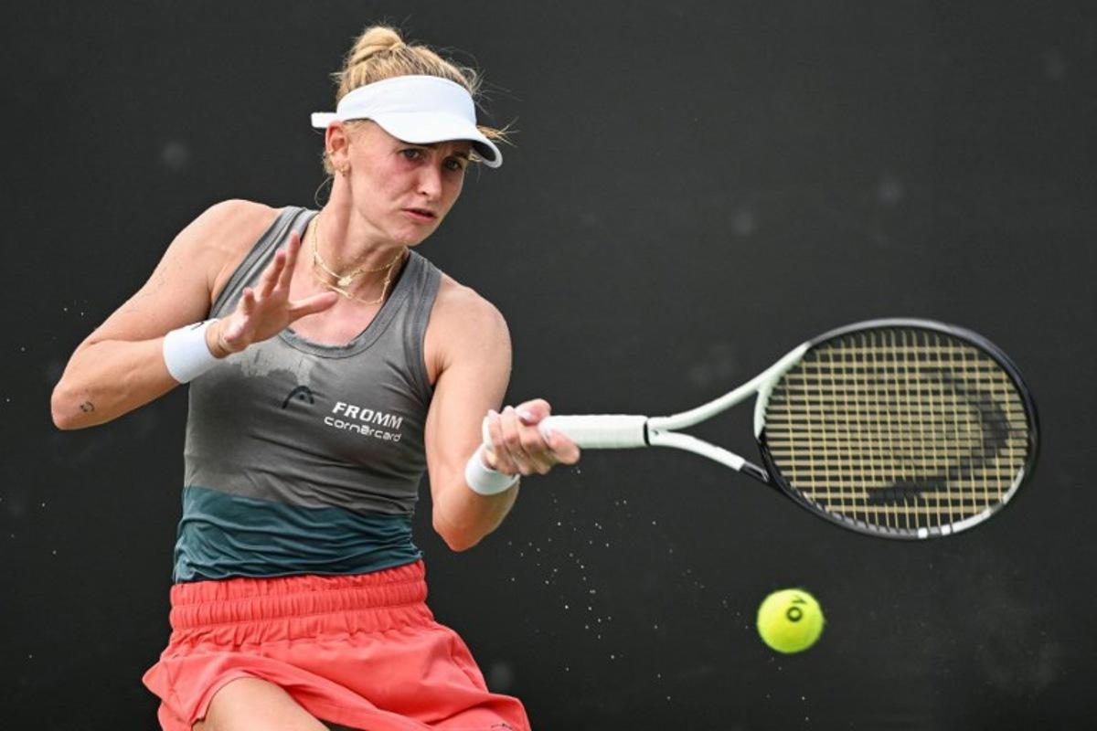 Jil Teichmann of Switzerland hits a return against Ma Yexin of China during their women's singles qualifying match prior to the start of the WTA Guangzhou Open tennis tournament in Guangzhou, southern China's Guangdong province, on September 16, 2023. Hector RETAMAL / AFP