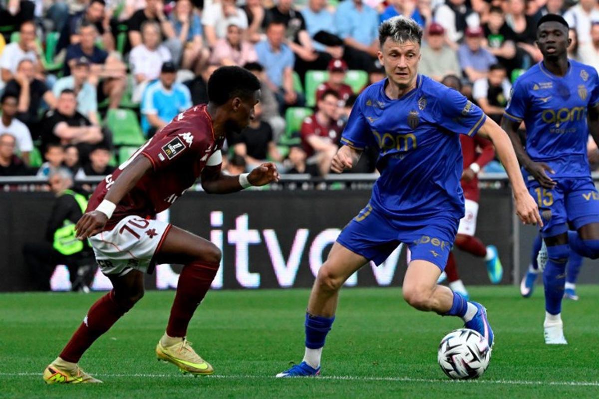 Metz's Senegalese defender #70 Bouna Sarr (L) fights for the ball with Monaco's Russian midfielder #10 Aleksandr Golovin during the French L1 football match between FC Metz and AS Monaco at the Stade Saint-Symphorien in Longeville-les-Metz, eastern France on May 2, 2026. Jean-Christophe VERHAEGEN / AFP