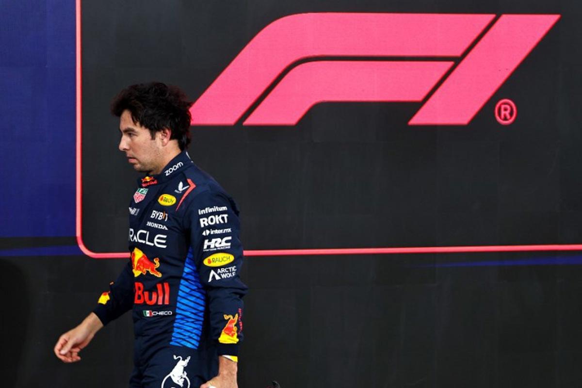 Red Bull Racing's Mexican driver Sergio Perez walks to his garage after the qualifying session ahead of the Abu Dhabi Formula One Grand Prix at the Yas Marina Circuit in Abu Dhabi on December 7, 2024. HAMAD I MOHAMMED / POOL / AFP