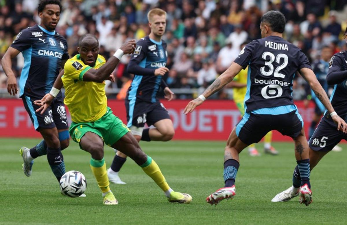 Nantes' Cameroonian forward #37 Ignatius Ganago (2nd L) fights for the ball with Marseille's Argentinian defender #32 Facundo Medina during the French L1 football match between FC Nantes and Olympique de Marseille at the Stade de la Beaujoire-Louis Fonteneau in Nantes, western France on May 2, 2026. Fred TANNEAU / AFP