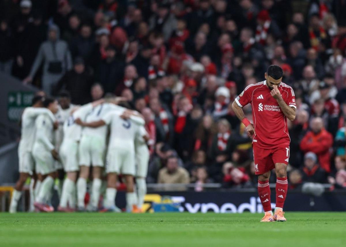 Liverpool's Egyptian striker #11 Mohamed Salah (R) reacts as Nottingham Forrest players (back L) celebrate after their third goal during the English Premier League football match between Liverpool and Nottingham Forest at Anfield in Liverpool, north west England on November 22, 2025. Darren Staples / AFP