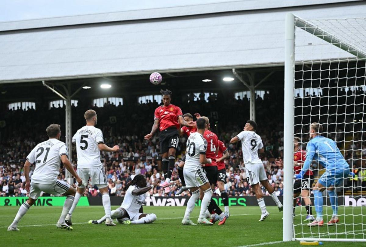 Manchester United's French defender #15 Leny Yoro (C) headers the ball to score the opening goal during the English Premier League football match between Fulham and Manchester United at Craven Cottage in London on August 24, 2025. JUSTIN TALLIS / AFP