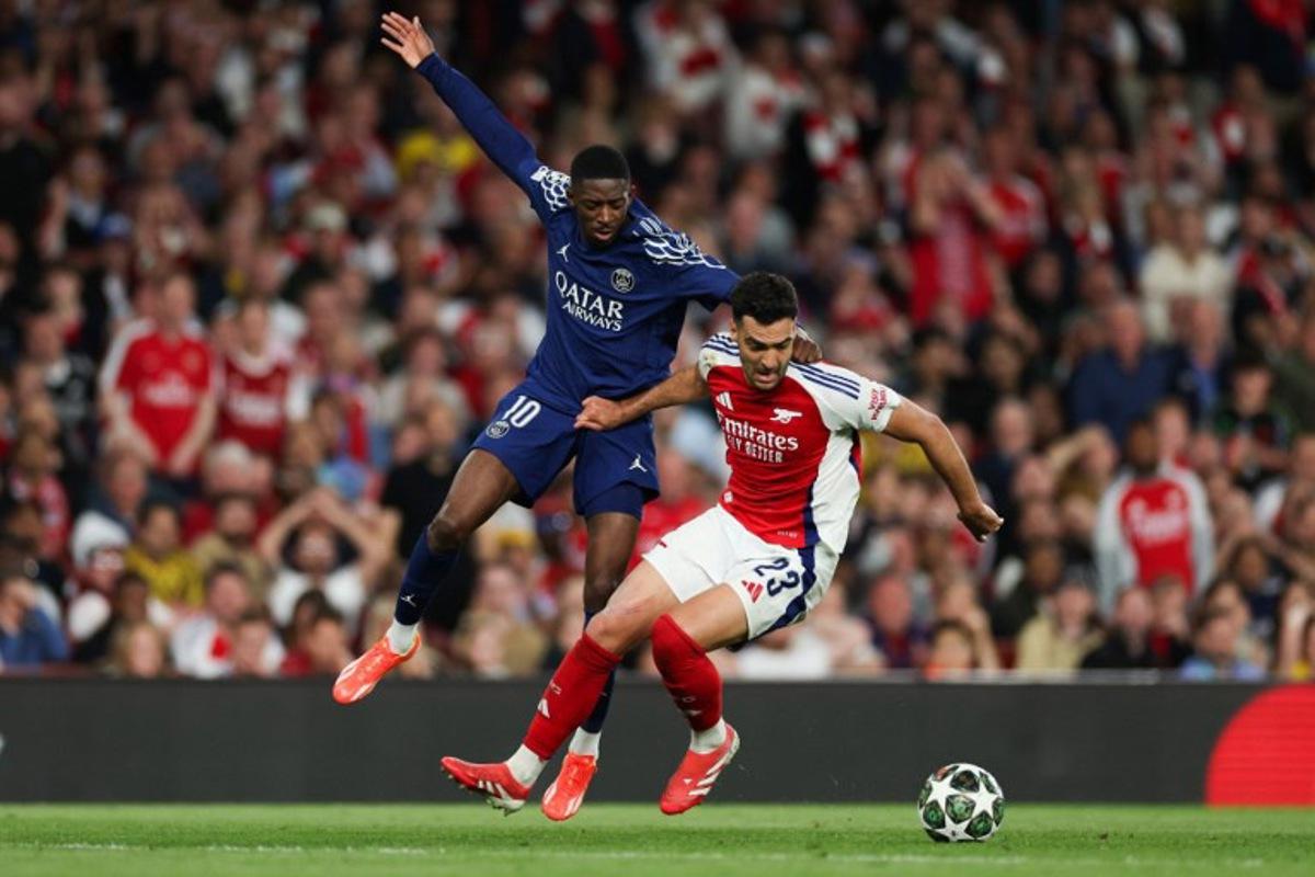 Paris Saint-Germain's French forward #10 Ousmane Dembele (L) fights for the ball with Arsenal's Spanish midfielder #23 Mikel Merino during the UEFA Champions League Semi-final First Leg football match between Arsenal and Paris Saint-Germain (PSG) at the Emirates Stadium in north London, on April 29, 2025. Adrian Dennis / AFP