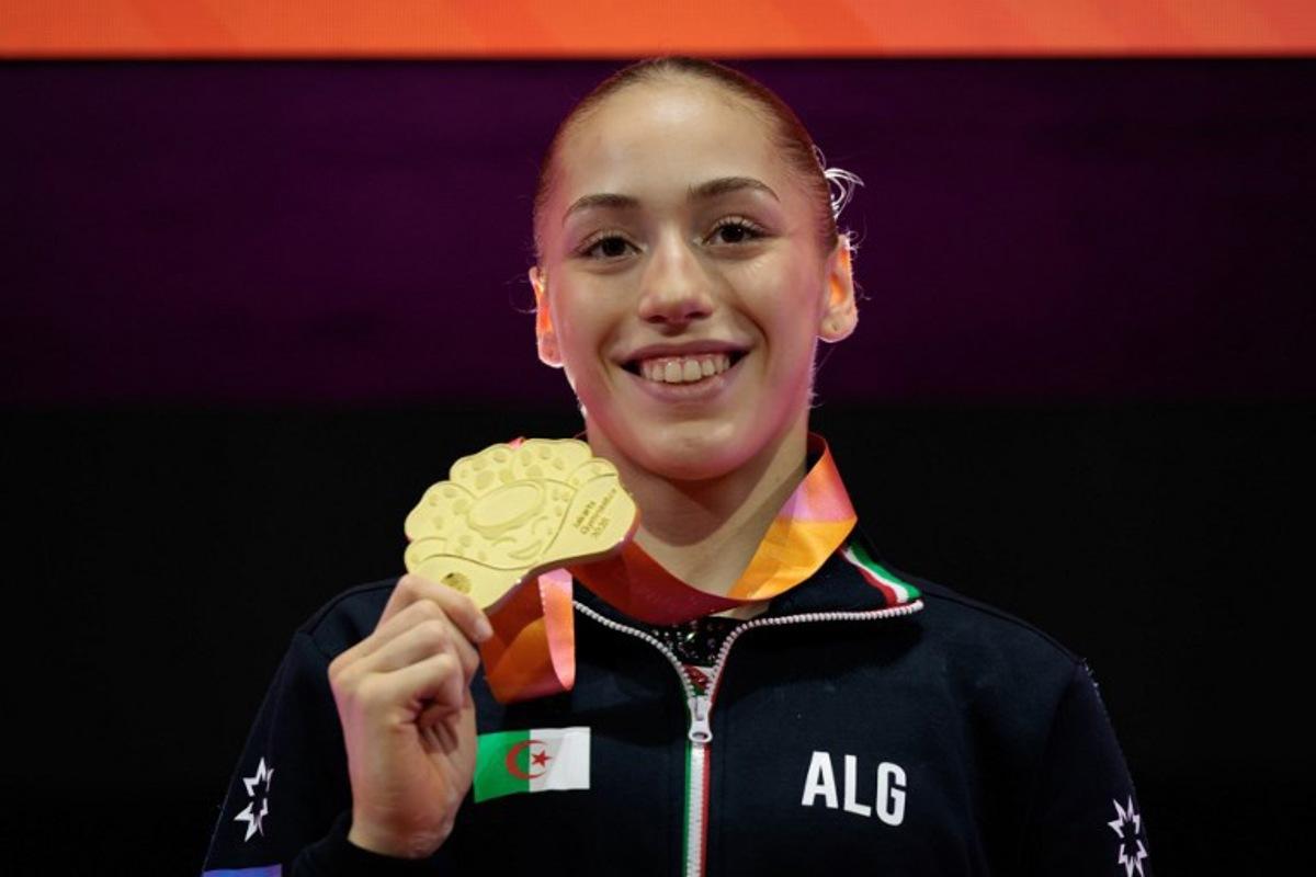 First-placed Algeria's Kaylia Nemour with the gold medal poses during the victory ceremony for the women's uneven bars final at the 53rd FIG Artistic Gymnastics World Championships in Jakarta on October 24, 2025. Yasuyoshi CHIBA / AFP