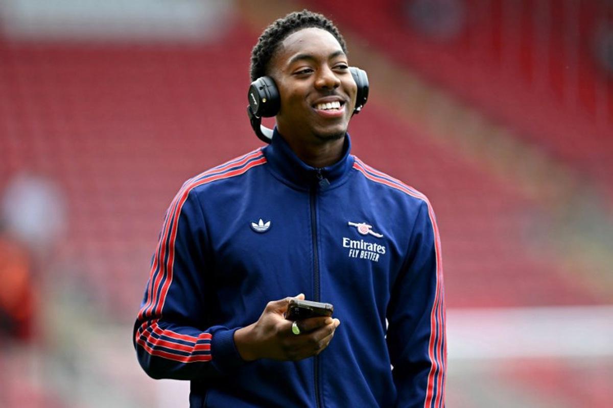 Arsenal's English midfielder #49 Myles Lewis-Skelly walks on the pitch with headphones before the English Premier League football match between Southampton and Arsenal at St Mary's Stadium in Southampton, southern England, on May 25, 2025. Glyn KIRK / AFP
