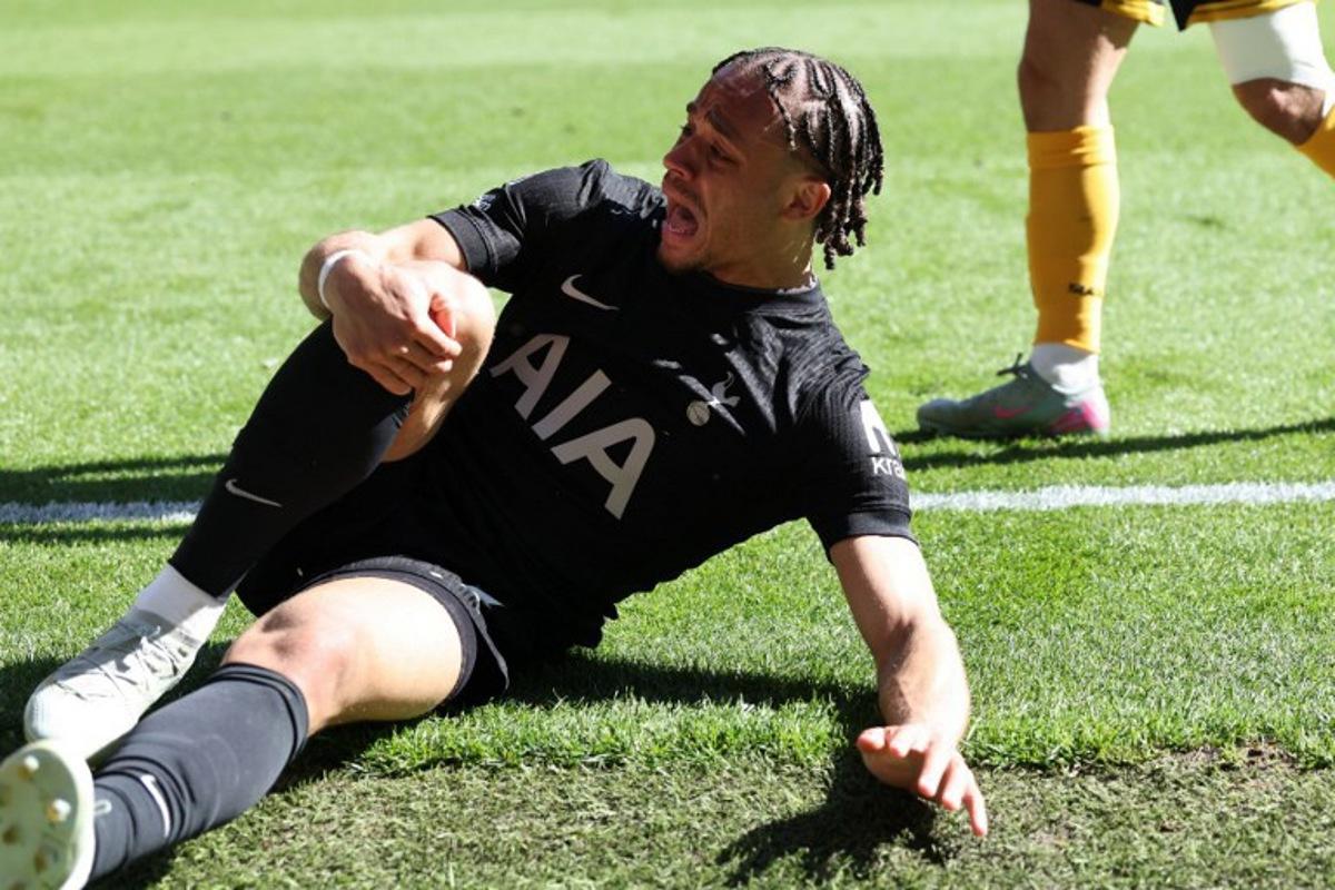 Tottenham Hotspur's Dutch midfielder #07 Xavi Simons reacts after suffering a knock during the English Premier League football match between Wolverhampton Wanderers and Tottenham Hotspur at the Molineux stadium in Wolverhampton, central England on April 25, 2026. Darren Staples / AFP