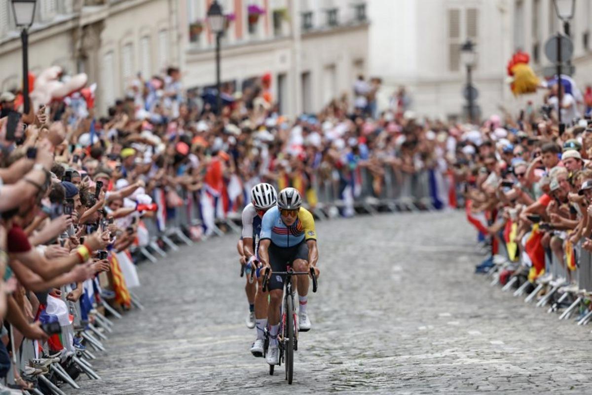 Belgium's Remco Evenepoel cycles ahead of France's Valentin Madouas in the Montmartre ascent during the men's cycling road race during the Paris 2024 Olympic Games in Paris, on August 3, 2024. Tim De Waele / POOL / AFP