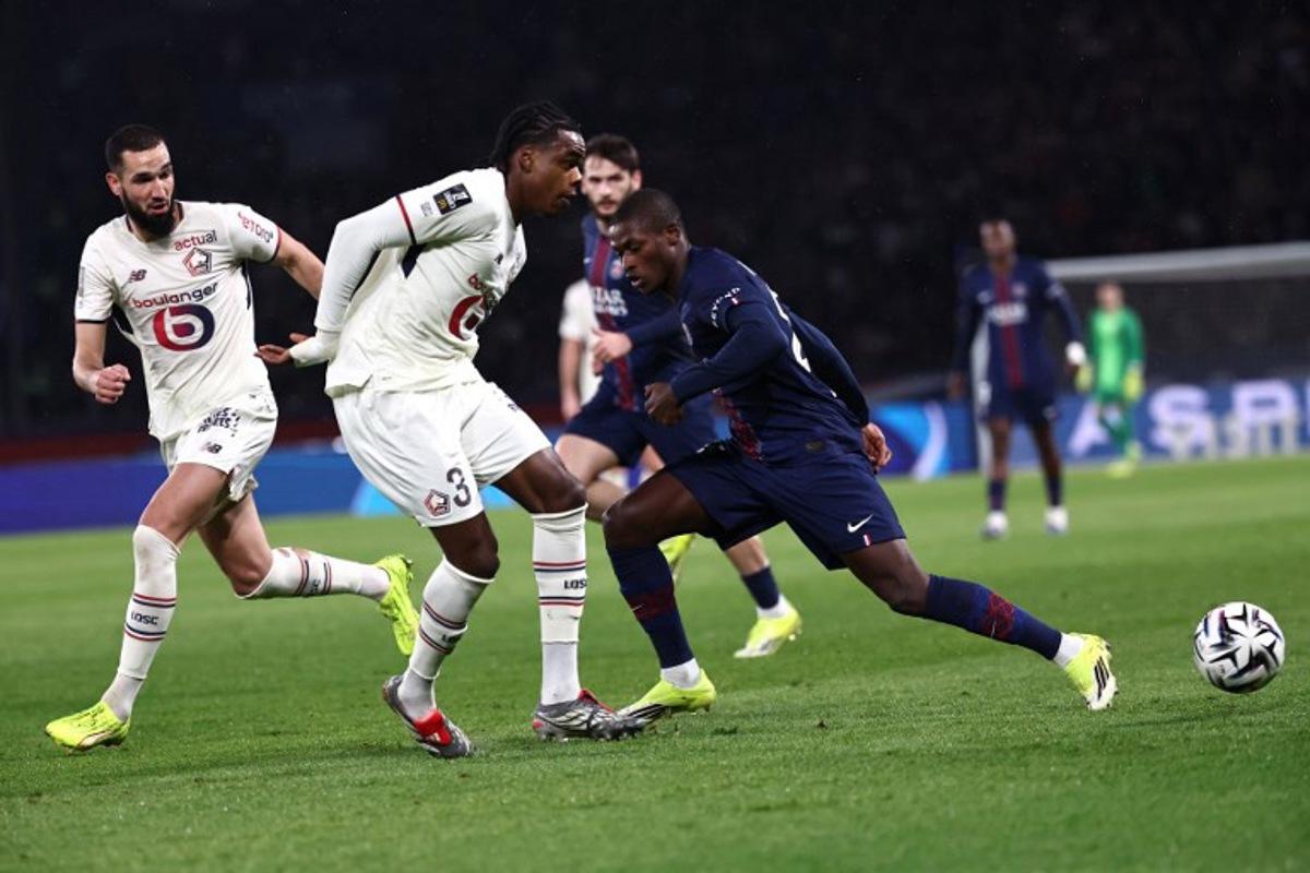 Paris Saint-Germain's Portuguese defender #25 Nuno Mendes (R) and Lille's Belgian defender #03 Nathan Ngoy (2L) fight for the ball during the French L1 football match between Paris Saint-Germain (PSG) and Lille LOSC at the Parc des Princes stadium in Paris on January 16, 2026. Anne-Christine POUJOULAT / AFP