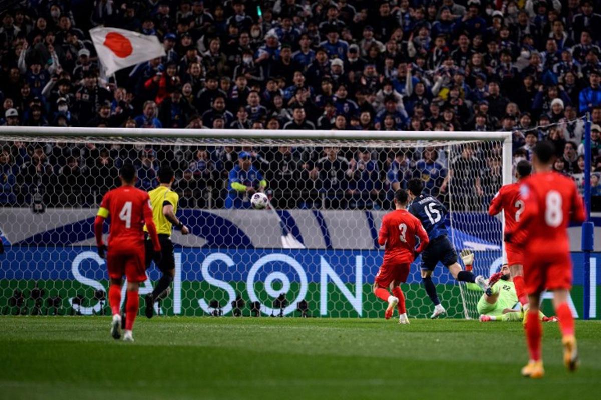 Japan's Daichi Kamada (#15) scores the goal during the 2026 FIFA World Cup Asian qualification football match between Japan and Bahrain in Saitama on March 20, 2025. Philip FONG / AFP