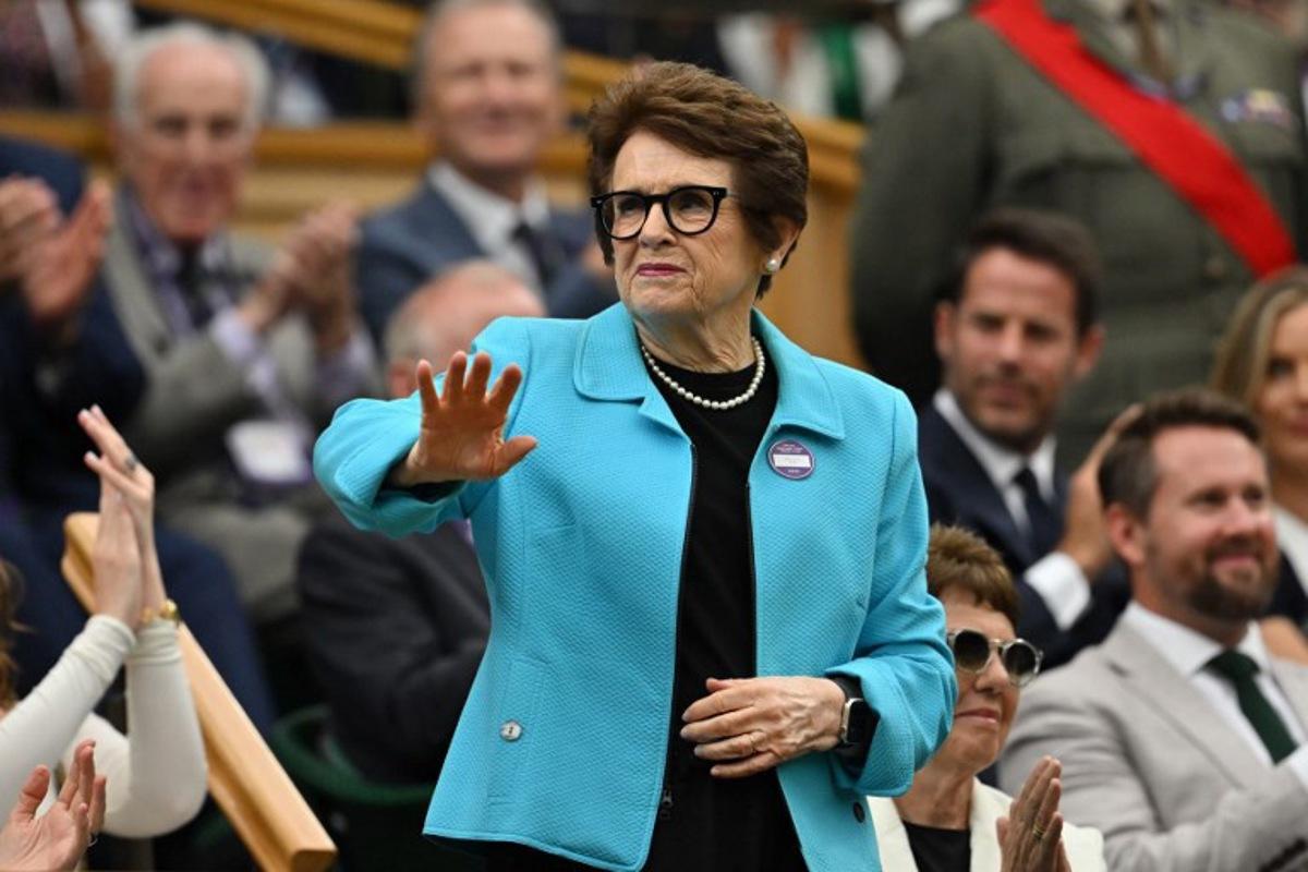 US former tennis player Billie Jean King waves to the crowd from the Royal box ahead of the men's singles third round tennis match between Italy's Jannik Sinner and Spain's Pedro Martinez on the sixth day of the 2025 Wimbledon Championships at The All England Lawn Tennis and Croquet Club in Wimbledon, southwest London, on July 5, 2025. Glyn KIRK / AFP
