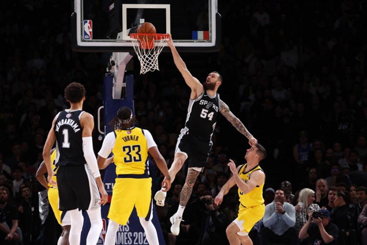San Antonio Spurs' Georgian-US forward-center #54 Sandro Mamukelashvili (C) jumps to the net during the NBA basketball game between the San Antonio Spurs and the Indiana Pacers at the Accor Arena - Palais Omnisports de Paris-Bercy - in Paris on January 25, 2025. FRANCK FIFE / AFP