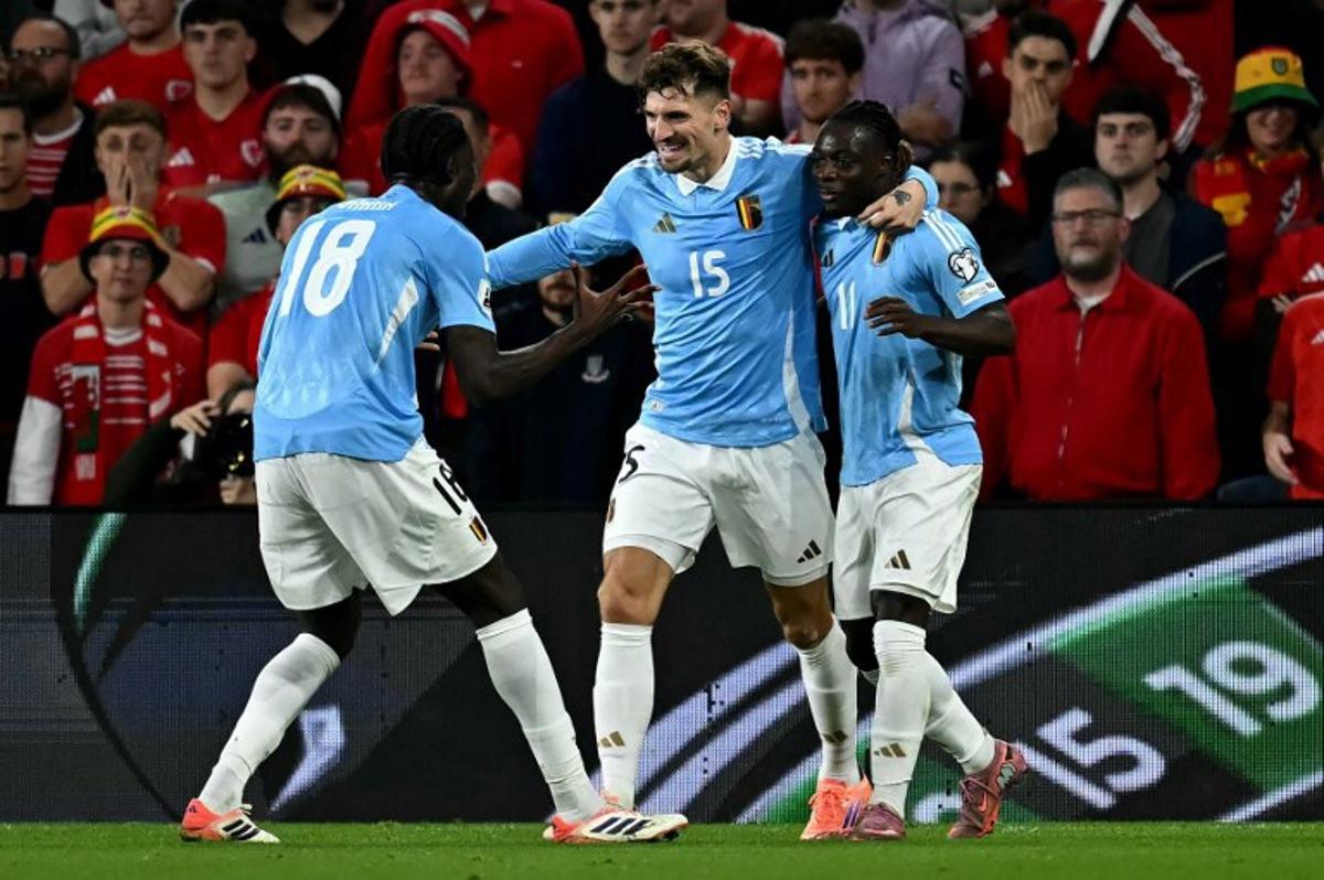 Belgium's defender #15 Thomas Meunier (C) celebrates scoring the team's second goal during the 2026 World Cup Group J qualifier football match between Wales and Belgium, at Cardiff City Stadium, in Cardiff, on October 13, 2025. Paul ELLIS / AFP