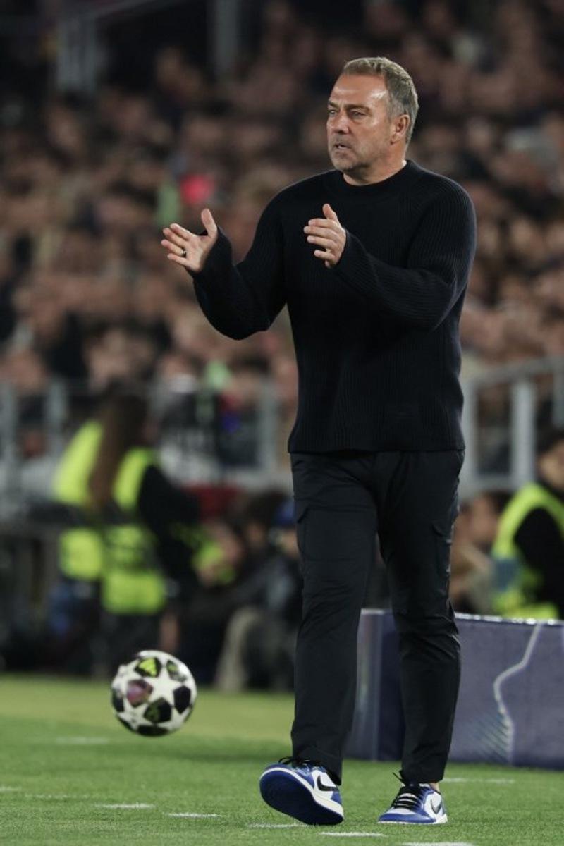 Barcelona's German coach Hans-Dieter Flick gestures to players during the UEFA Champions League quarter final first leg football match between FC Barcelona and Club Atletico de Madrid at Camp Nou Stadium in Barcelona on April 8, 2026. Lluis GENE / AFP