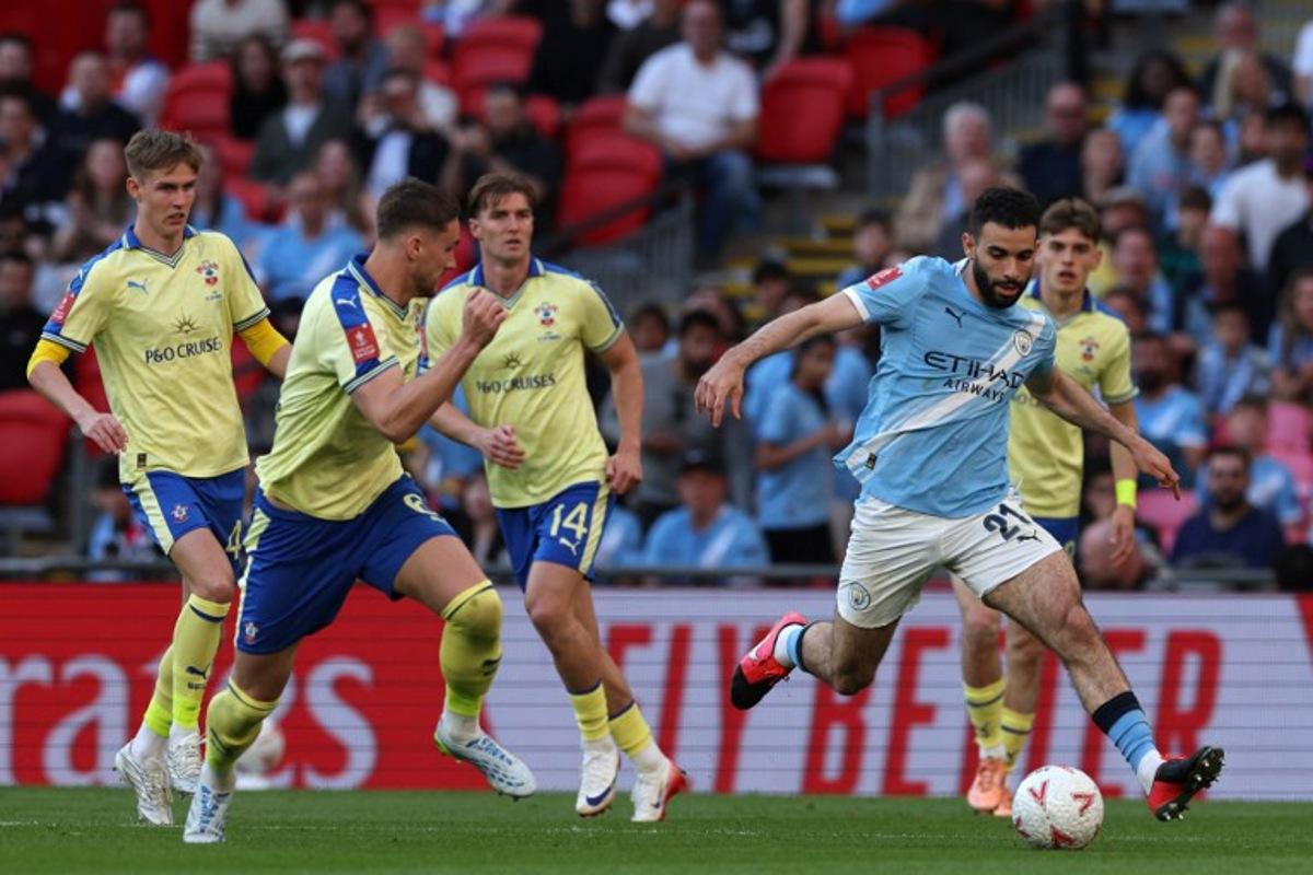 Manchester City's Algerian defender #21 Rayan Ait-Nouri (R) runs with the ball during the English FA Cup semi final football match between Manchester City and Southampton at Wembley stadium in London, on April 25, 2026. Adrian Dennis / AFP