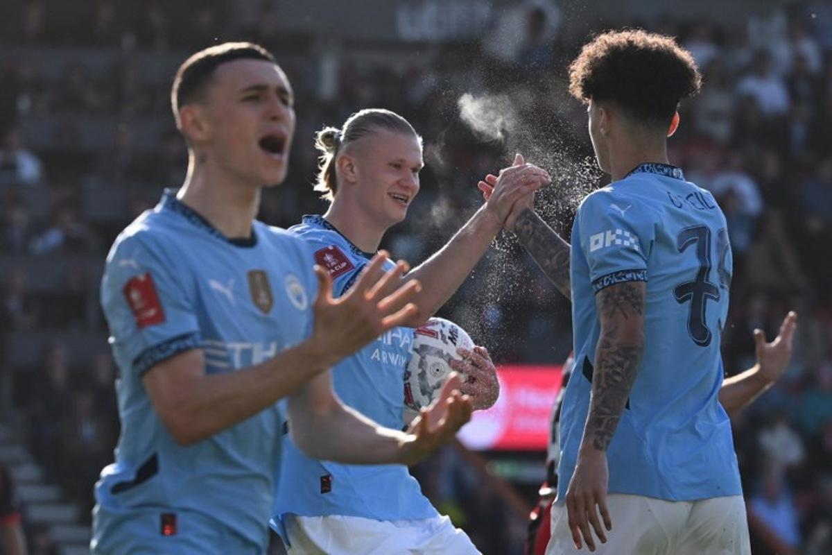 Manchester City's Norwegian striker #09 Erling Haaland (C) celebrates with Manchester City's English midfielder #75 Nico O'Reilly (R) after the two combine for their first goal during the English FA Cup quarter-final football match between Bournemouth and Manchester City at the Vitality Stadium in Bournemouth, on the south coast of England on March 30, 2025. JUSTIN TALLIS / AFP
