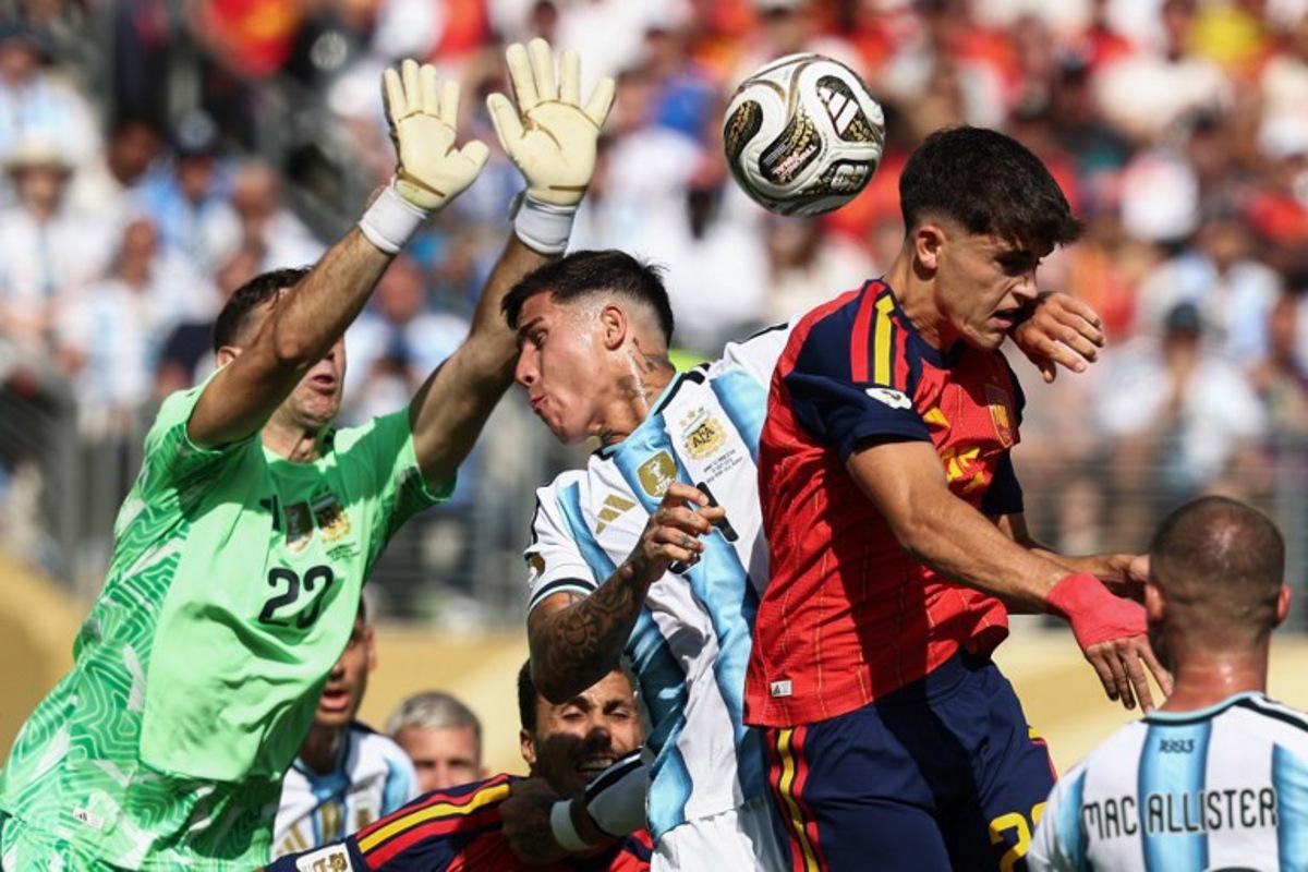 Argentina's midfielder #24 Enzo Fernandez and Spain's defender #22 Pau Cubarsi fight for the ball past Argentina's goalkeeper #23 Emiliano Martinez during the 2026 World Cup football tournament final match between Spain and Argentina at the New York/New Jersey Stadium in East Rutherford on July 19, 2026. FRANCK FIFE / AFP