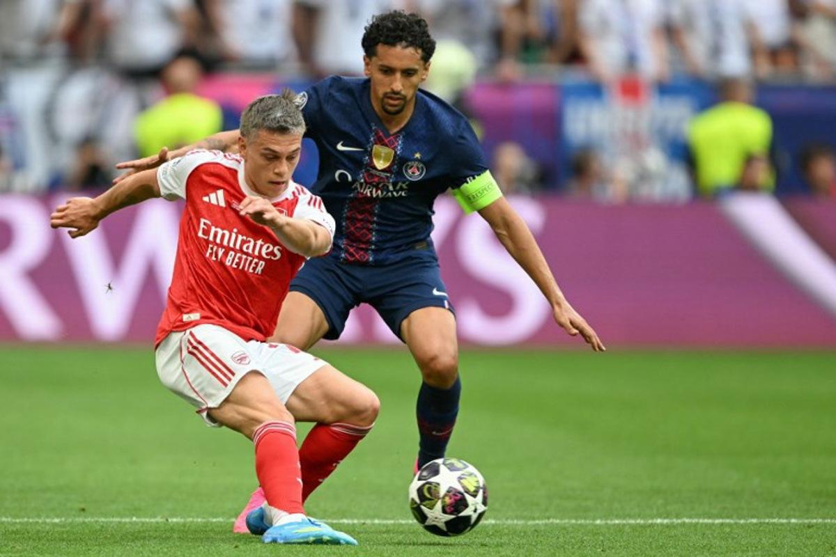Arsenal's Belgian midfielder #19 Leandro Trossard (L) and Paris Saint-Germain's Brazilian defender #05 Marquinhos vie for the ball during the UEFA Champions League final football match between Paris Saint-Germain (PSG) and Arsenal FC at the Puskas Arena in Budapest on May 30, 2026. NICOLAS TUCAT / AFP