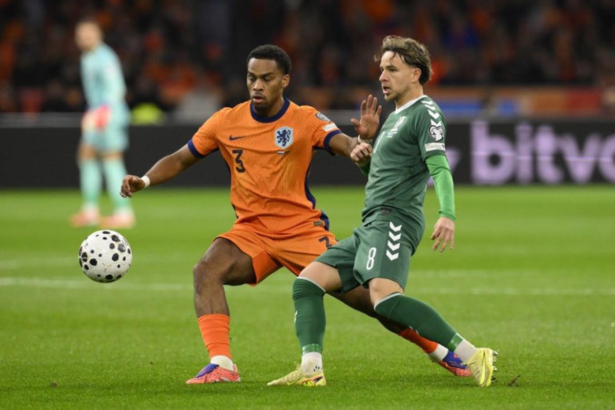 Netherlands' defender #03 Jurrien Timber (L) and Lithuania's midfielder #08 Tomas Kalinauskas (R) fight for the ball during the FIFA World Cup 2026 Group G European qualification football match between the Netherlands and Lithuania at the Johan Cruijff Arena, in Amsterdam, on November 17, 2025. JOHN THYS / AFP