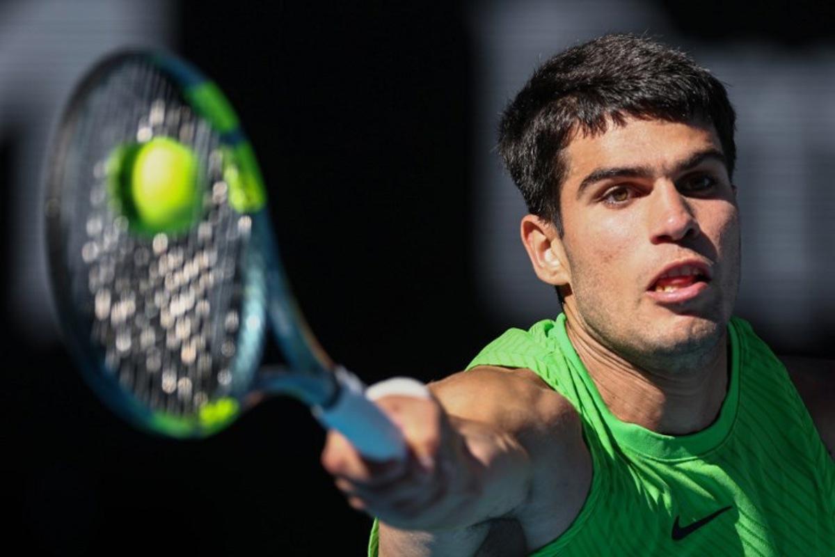 Spain's Carlos Alcaraz hits a return against Germany's Alexander Zverev during their men's singles semi-final match on day thirteen of the Australian Open tennis tournament in Melbourne on January 30, 2026. IZHAR KHAN / AFP