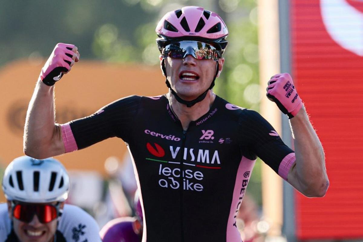 Team Visma-Lease a Bike's Dutch rider Olav Kooij celebrates after victory as he crosses the finish of the 21st and last stage of the 108th Giro d'Italia cycling race of 143kms from Rome to Rome on June 1, 2025. Luca Bettini / AFP