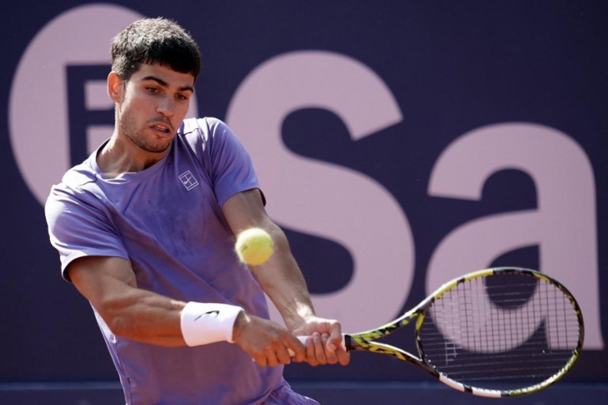 Spain's Carlos Alcaraz returns the ball to France's Arthur Fils during the ATP Barcelona Open "Conde de Godo" tennis tournament singles semi-final match at the Real Club de Tenis in Barcelona, on April 19, 2025. MANAURE QUINTERO / AFP