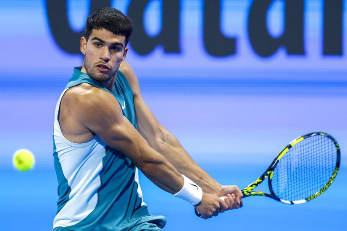 Spain's Carlos Alcaraz hits a return to Italy's Luca Nardi during their men's singles match at the ATP Qatar Open tennis tournament in Doha on February 19, 2025. KARIM JAAFAR / AFP