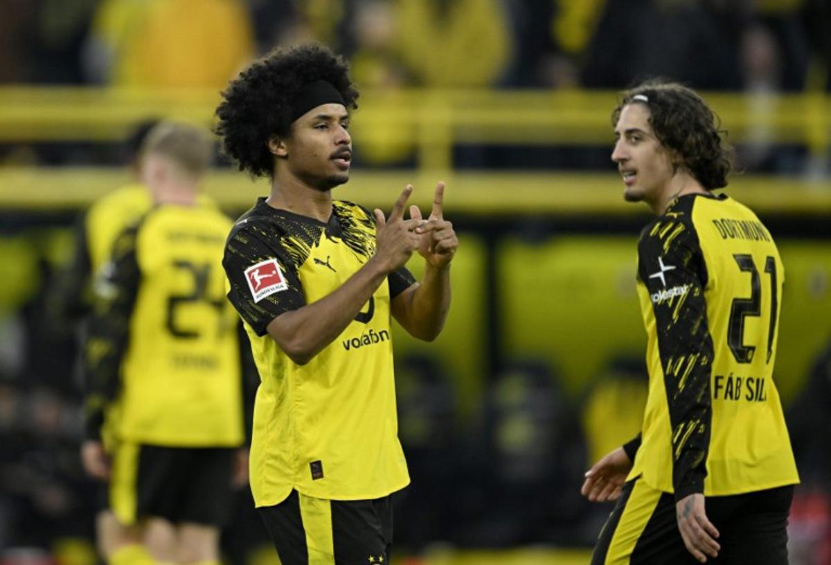 Dortmund's German forward #27 Karim Adeyemi (L) celebrates after scoring the 2-0 goal during the German first division Bundesliga football match between BVB Borussia Dortmund and FC St Pauli in Dortmund, western Germany, on January 17, 2026. INA FASSBENDER / AFP
