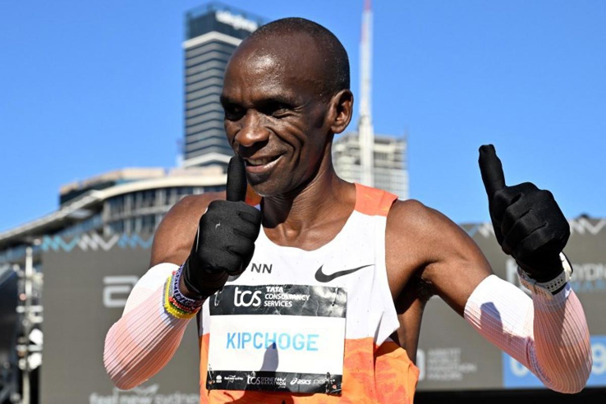 Kenya's Eliud Kipchoge gestures to fans after crossing the finish line during the 2025 Sydney Marathon at the Opera House on August 31, 2025. Saeed KHAN / AFP