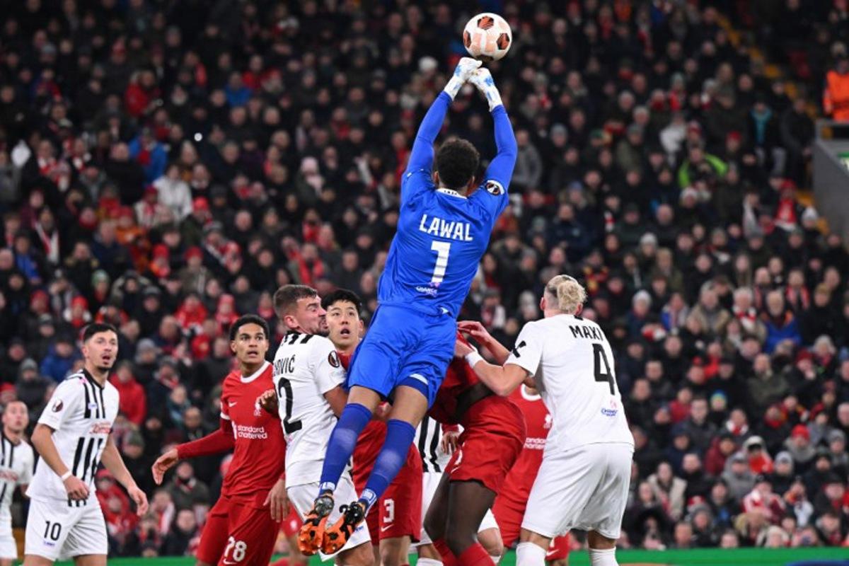 Linz's Austrian goalkeeper #01 Tobias Lawal punches the ball clear during the UEFA Europa League group E football match between Liverpool and Linzer ASK at Anfield in Liverpool, north west England on November 30, 2023. Oli SCARFF / AFP