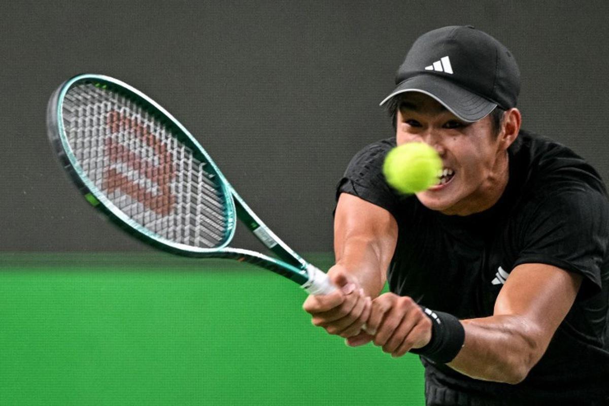 United States's Learner Tien hits a return to Russia's Daniil Medvedev during their men's singles match at the Shanghai Masters tennis tournament in Shanghai on October 8, 2025. HECTOR RETAMAL / AFP
