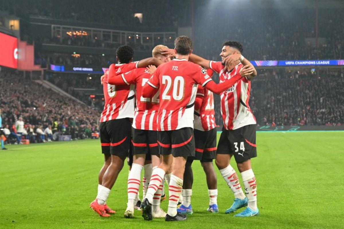 PSV's players celebrate after scoring their first goal during the UEFA Champions League 1st round day 2 football match between PSV Eindhoven (NED) and Sporting Lisbon (POR) at the The Philips Stadion, in Eindhoven, on October 1, 2024. NICOLAS TUCAT / AFP