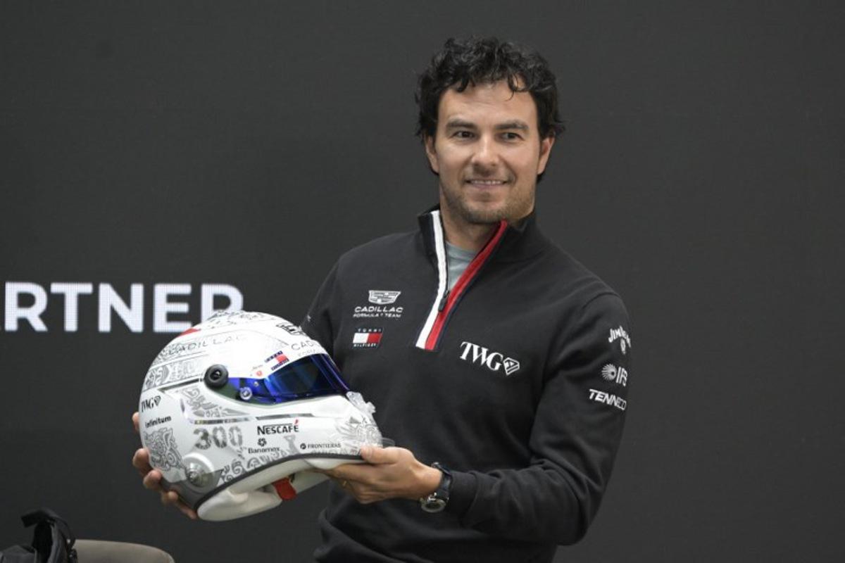 Mexican F1 driver Sergio Perez of Cadillac Team shows his helmet during a press conference in Mexico City, on October 27, 2026, ahead of the upcoming Mexico GP. Alfredo ESTRELLA / AFP