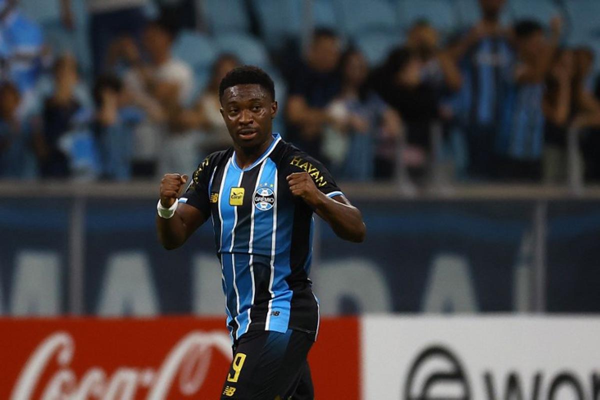 Gremio's Belgian midfielder #09 Francis Amuzu celebrates after scoring his team's first goal during the Copa Sudamericana group stage football match between Brazil's Gremio and Argentina's Deportivo Riestra at the Arena do Gremio stadium in Porto Alegre, state of Rio Grande do Sul, Brazil, on April 14, 2026. SILVIO AVILA / AFP