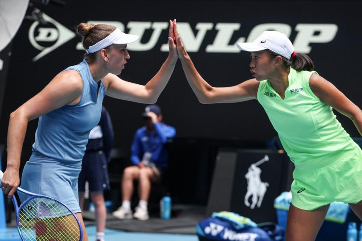 Belgium's Elise Mertens (L) reacts on a point with partner China's Zhang Shuai during their women's doubles final match against Kazakhstan's Anna Danilina and Serbia's Aleksandra Krunic on day fourteen of the Australian Open tennis tournament in Melbourne on January 31, 2026. DAVID GRAY / AFP