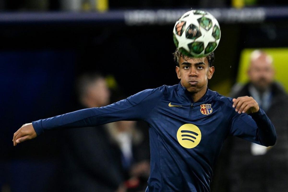 Barcelona's Spanish forward #19 Lamine Yamal warms up on the ball prior to the UEFA Champions League quarter-final second leg football match between BVB Borussia Dortmund and FC Barcelona in Dortmund, western Germany on April 15, 2025. INA FASSBENDER / AFP