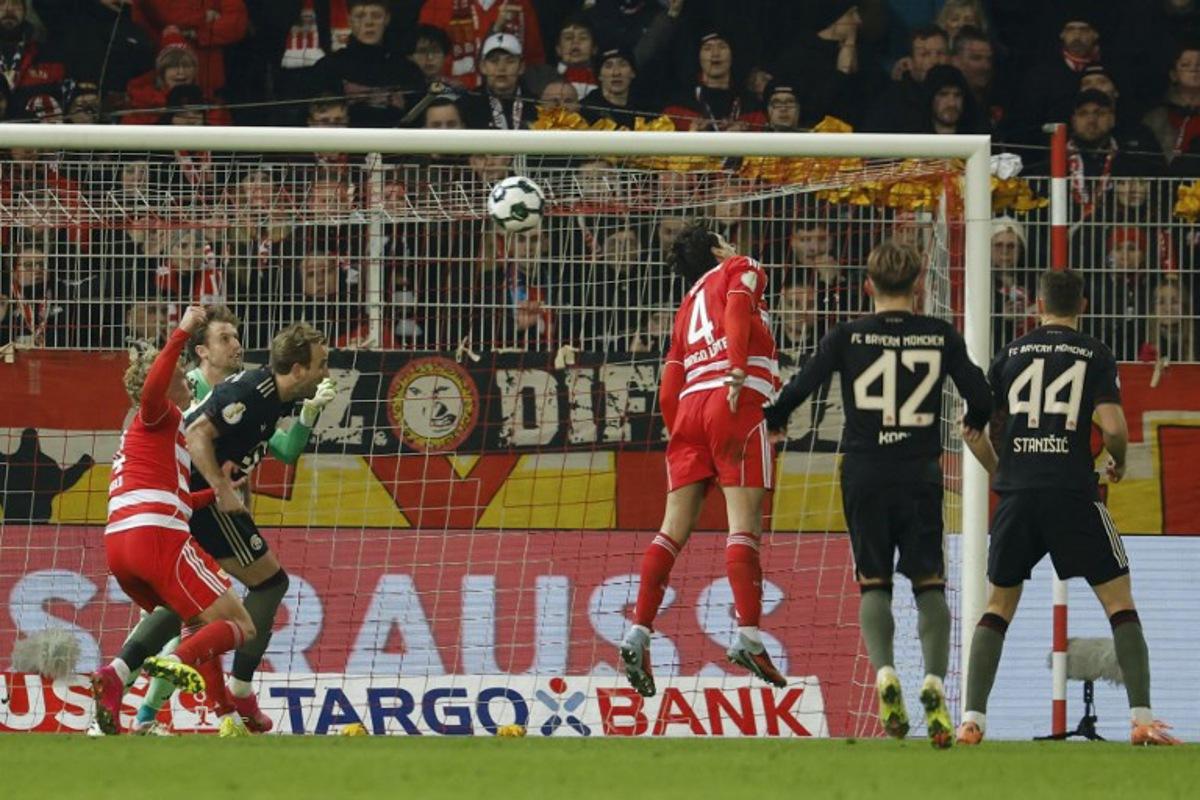 Union Berlin's Danish goalkeeper #01 Frederik Ronnow (2L) reacts as Union Berlin's Portuguese defender #04 Diogo Leite (C) heads the ball to score an own goal during the German Cup (DFB-Pokal) round of 16 football match between 1 FC Union Berlin and FC Bayern Munich in Berlin on December 3, 2025. Odd ANDERSEN / AFP