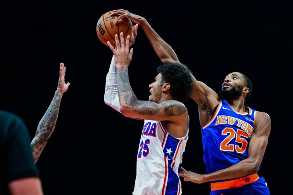 New York Knicks' #25 Mikal Bridges (R) defends against Philadelphia 76ers' #25 Dominick Barlow during the NBA basketball game between the New York Knicks and the Philadelphia 76ers at the Etihad Arena in Abu Dhabi on October 4, 2025. Giuseppe CACACE / AFP