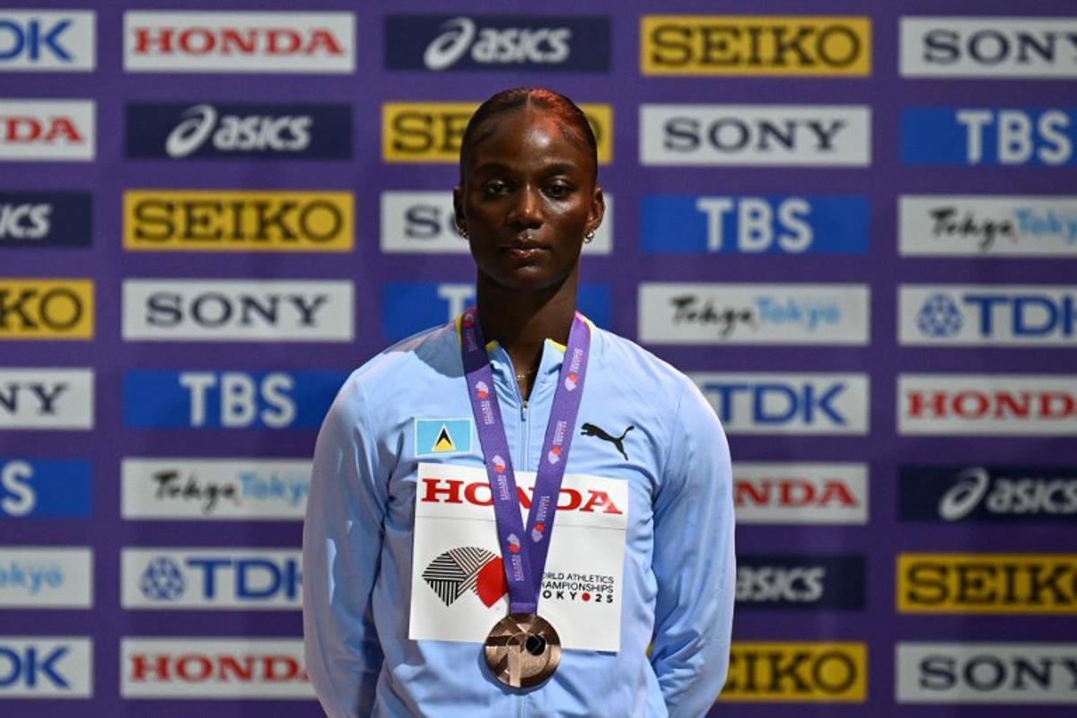 Bronze medallist Saint Lucia's Julien Alfred poses with her medal on the podium for the women's 100m final during the World Athletics Championships in Tokyo on September 15, 2025. Philip FONG / AFP