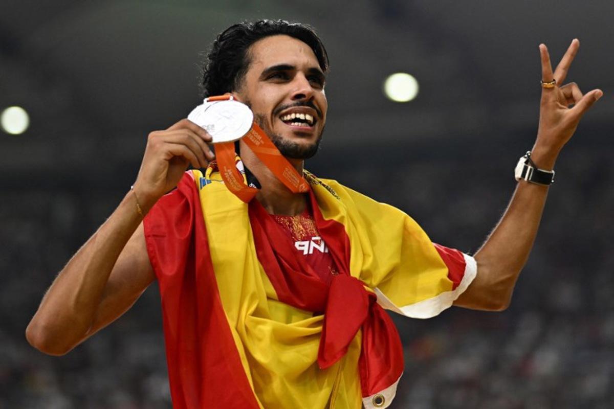 Spain's silver medallist Mohamed Katir celebrates with his medal and national flag after finishing second in the men's 5000m final during the World Athletics Championships at the National Athletics Centre in Budapest on August 27, 2023. Jewel SAMAD / AFP