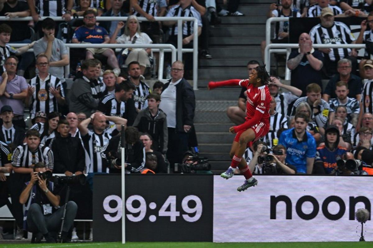 Liverpool's English striker #73 Rio Ngumoha celebrates in front of the Newcastle fans after scoring their third goal during the English Premier League football match between Newcastle United and Liverpool at St James' Park in Newcastle-upon-Tyne, north east England on August 25, 2025. ANDY BUCHANAN / AFP